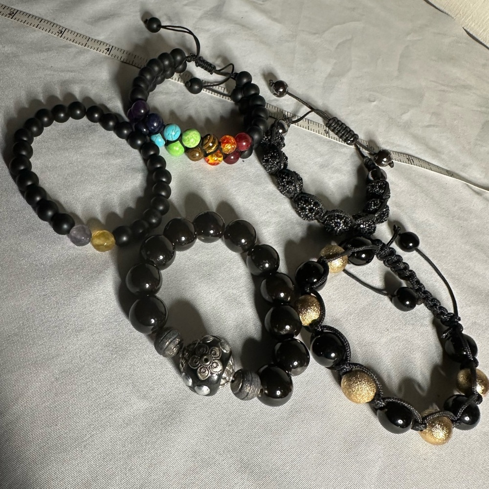 Five black adjustable and stretch style bracelets